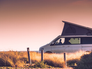Camper van with roof top tent camp on beach © Voyagerix