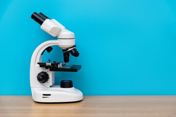 Close up of microscope on wooden table