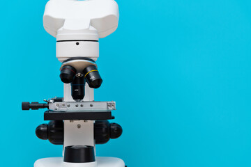 Close up of microscope on blue background