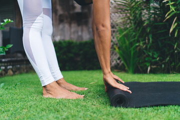 Girl preparing fitness mat for exercise or yoga