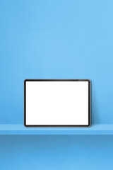 Digital tablet pc on blue wall shelf. Vertical background banner