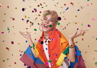 Youth asian transgender LGBT celebrate and confetti with Rainbow flag isolated over nude color...