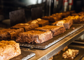 several tasty chocolate cakes on display in a cafe