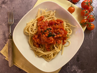 Spaghetti pasta with ragu di salsiccia, tomato sauce and cherry tomatoes.