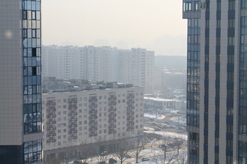 Fototapeta premium Skyscrapers with reflective windows in foggy sunlight