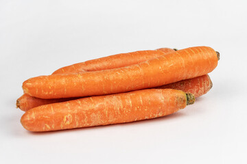 Heap of fresh carrots on gray background