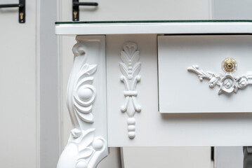 Decorative details on a white table with glass top