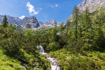 Fototapeta na wymiar Wonderful summer day hike along Lake Seebensee waterfall