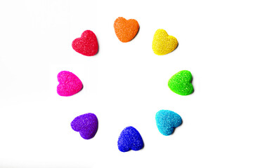 Round frame of rainbow gummy hearts on a white background. Valentine's day concept.