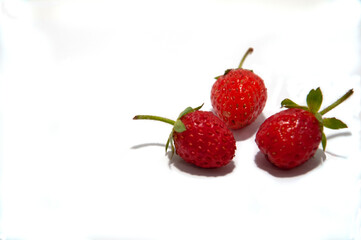 Strawberries lie in a circle in the form of a flower on a white background. High quality photo