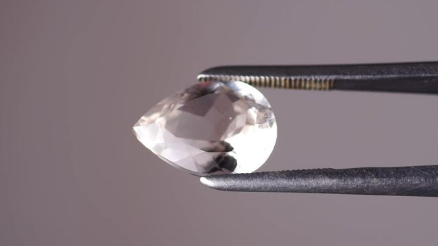 imperial champagne yellow topaz pear cut in the turning tweezers