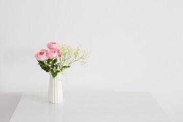 bouquet of pink roses in ceramic white vase  on white background