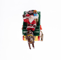 Fototapeta na wymiar toy santa claus on carriage isolated on white background