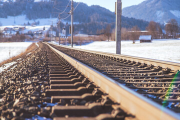 Sustainable traveling by train: Electric rail track in winter
