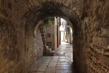Fototapeta na wymiar Ancient street with cobblestones in the historical center of Split, Dalmatia, Croatia