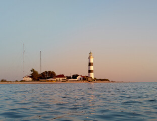 Fototapeta premium View of a lighthouse. Lighthouse on Tendra Spit, Kherson Oblast, Ukraine. Copy space.