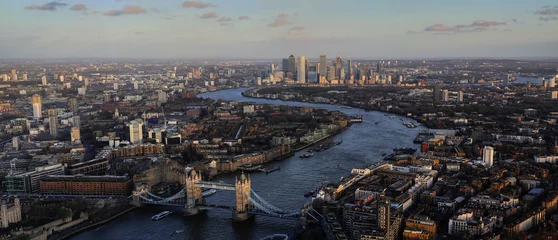 Gordijnen Sunset panorama of London with the most iconic symbol of London, Tower Bridge illuminated by the last rays of the sun before sunset. © Silviu