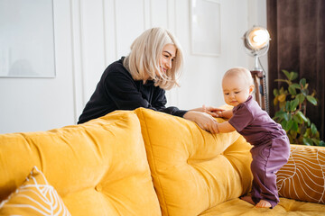 mother with child on a yellow sofa flowers