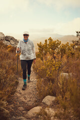 Are we there yet. Shot of a mature woman hiking in nature.