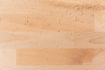 Background of wooden board with scattered sawdust