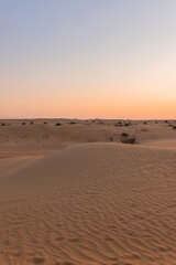 Desert sunset with empty dunes in Dubai or Abu Dhabi, United Arab Emirates