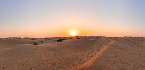 Obraz na płótnie Canvas Desert sunset with empty dunes in Dubai or Abu Dhabi, United Arab Emirates