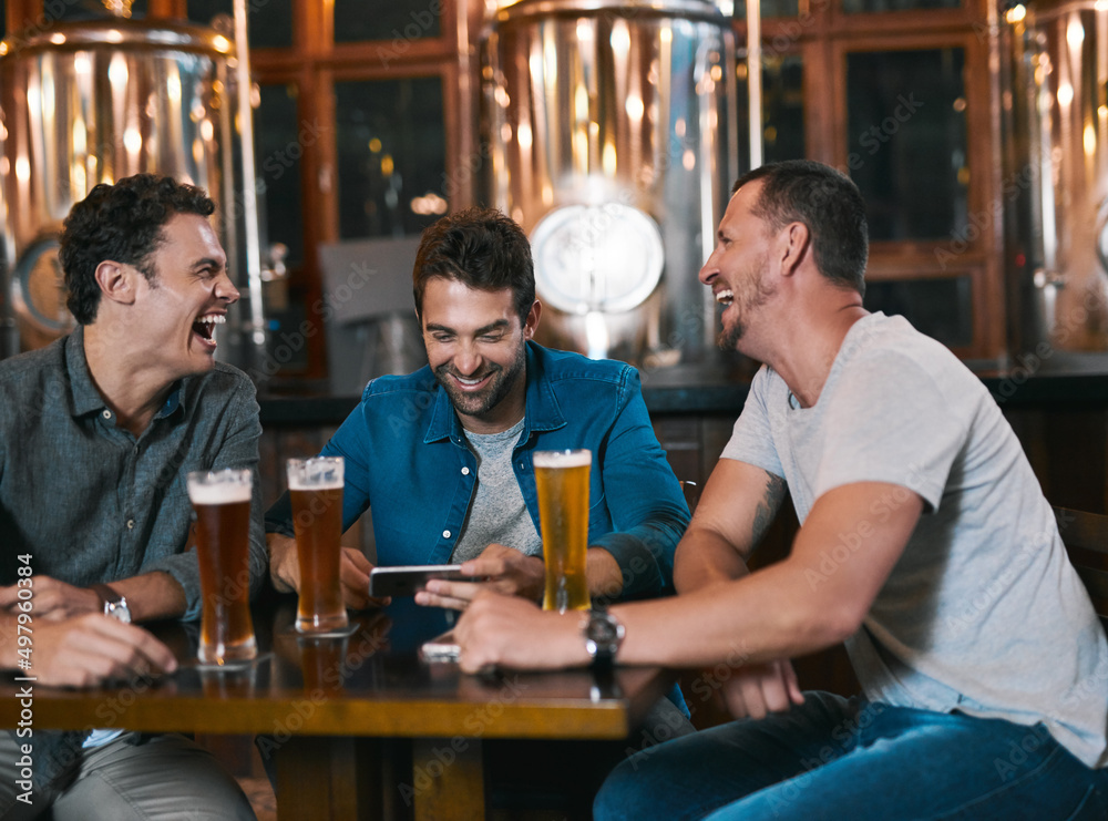 Aufkleber time to talk business over a beer. shot of three cheerful young men drinking beer together at a tabl