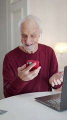 An elderly man is not good at managing a smartphone. He presses the screen but nothing happens