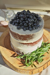  Rustic Homemade Naked Layered Wedding Cake with Vanilla Icing, Fresh Blueberries, and Rosemary