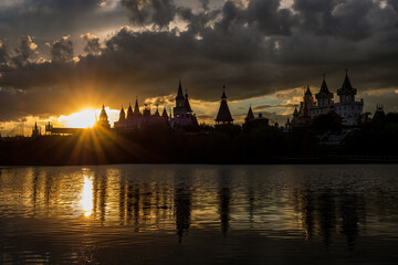 Beautiful view of the Kremlin Izmailovo through a silver-grape pond at sunset