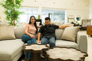 Cheerful couple likes a new couch