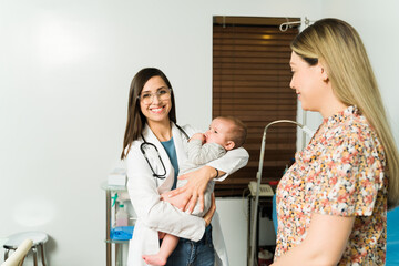 Fototapeta premium Female pediatrician with a baby at the hospital