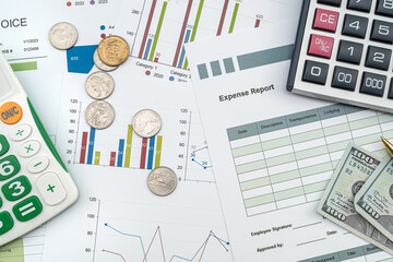 documents with graphs and diagrams and pen calculator us dollar on deks