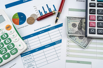  US dollar banknotes with pen on charts and graphs paper, accounting concept