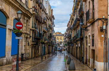 Naklejka premium A view down a balconied side street in the city of Tarragona on a spring day
