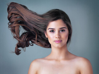 Dont hold your breath any longer for good hair. Studio shot of a beautiful young woman posing against a gray background.