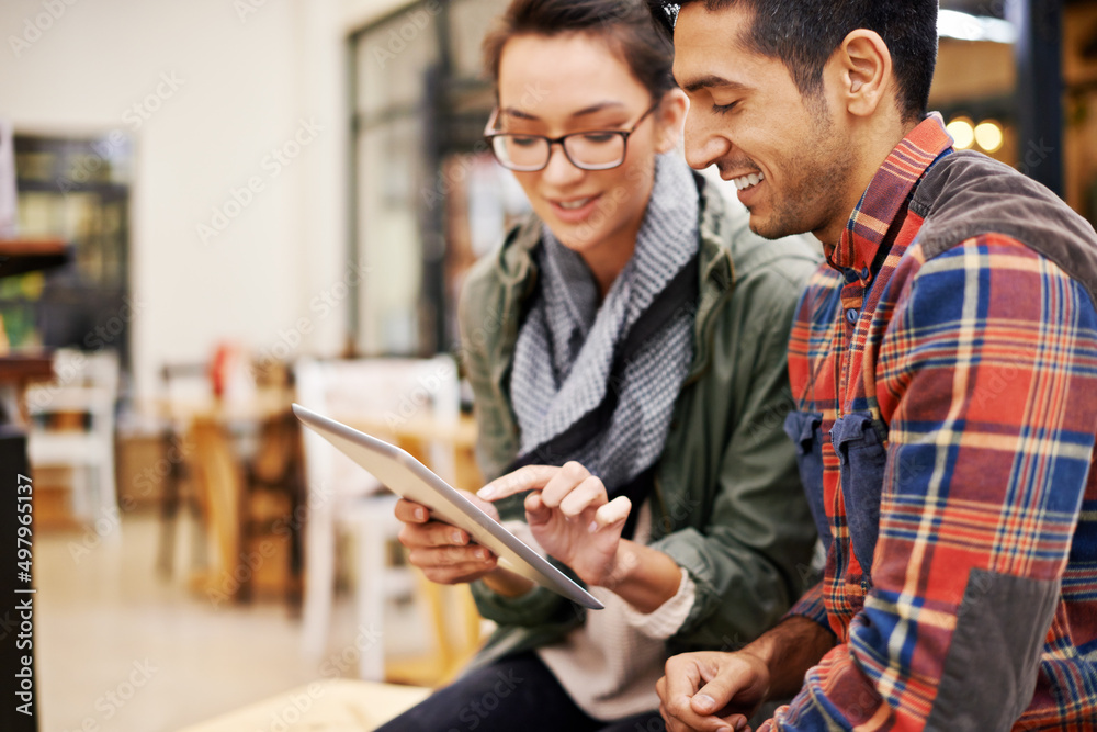 Aufkleber technology makes planning their evening easy. cropped shot of a young couple using a digital tablet 