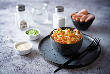 Funchosa with shrimp and vegetables in a plate Pad Thai