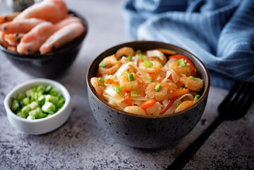Funchosa with shrimp and vegetables in a plate Pad Thai