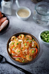 Funchosa with shrimp and vegetables in a plate Pad Thai