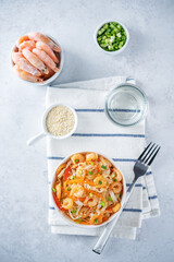 Funchosa with shrimp and vegetables in a plate Pad Thai