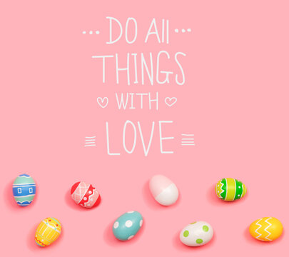 Do all things with love message with Easter eggs on a pink background