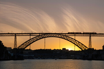 Fototapeta na wymiar Silhouette of the train on the Ponte Luís I in sunset in Porto, Portugal