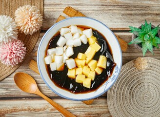 Stuffed fairy grass jelly in a bowl top view on wooden table taiwan food