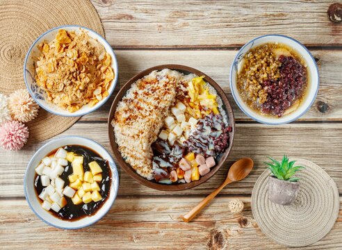 Stuffed fairy grass jelly, Brown Sugar Ice Cream, Peanut Noodle Tea, Tofu with seeds and beans, in a dish side view on wooden table taiwan food