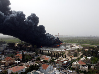 Acre, Israel - April 8 2022: Bahai construction site caught fire and huge smoke pillar covering residential neighborhood 