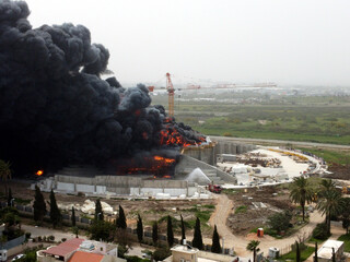 Acre, Israel - April 8 2022: Bahai construction site caught fire and huge smoke pillar covering residential neighborhood 