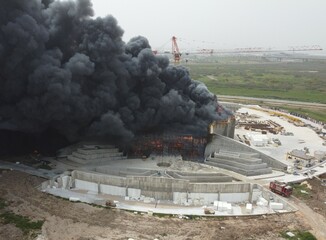 Acre, Israel - April 8 2022: Bahai construction site caught fire and huge smoke pillar covering residential neighborhood 