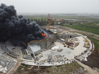 Acre, Israel - April 8 2022: Bahai construction site caught fire and huge smoke pillar covering residential neighborhood 