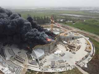 Acre, Israel - April 8 2022: Bahai construction site caught fire and huge smoke pillar covering residential neighborhood 